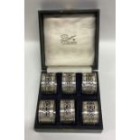 A boxed set of six silver pierced napkin rings. Bi