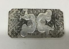 A heavy Chinese ingot decorated with figures. Punc