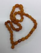 A graduated string of butterscotch amber beads wit