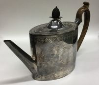 An oval Georgian silver teapot with bright cut dec