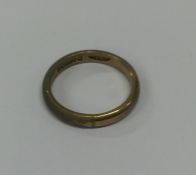 A 9 carat plain wedding band. Approx. 3.3 grams. E