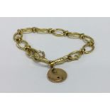 An 18 carat fancy link bracelet with ring clasp. A