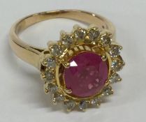 A large 18 carat gold ruby and diamond cluster rin