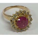 A large 18 carat gold ruby and diamond cluster rin