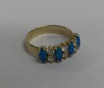 An opal and diamond ten stone ring in 14 carat cla