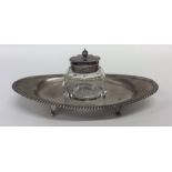 An Edwardian silver boat shaped inkwell with gadro