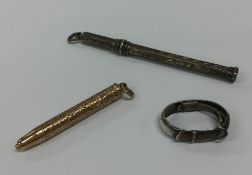 A small gold extending pencil, scarf clip etc. App