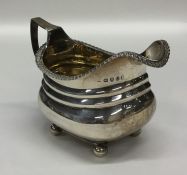 A Georgian silver cream jug with gilt interior and
