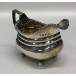 A Georgian silver cream jug with gilt interior and