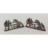 A pair of unusual silver menu holders depicting be