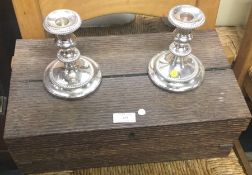 An old oak writing box together with candlesticks.