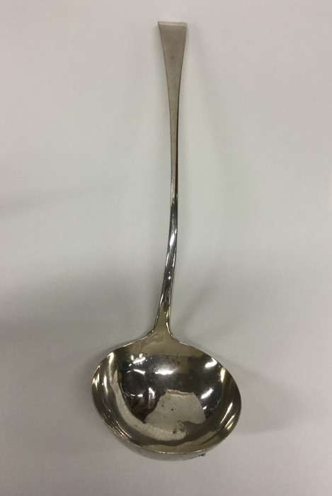 A Georgian OE pattern silver bottom marked ladle.