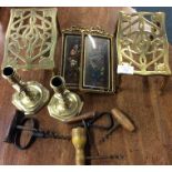 A pair of brass trivets, corkscrews etc.