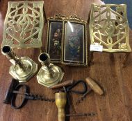 A pair of brass trivets, corkscrews etc.