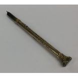 A small gold extending pencil / quill engraved wit