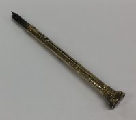A small gold extending pencil / quill engraved wit