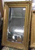 A gilt framed mirror.