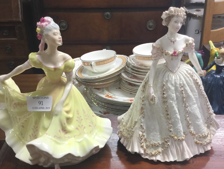 Two Royal Doulton figures of ladies.