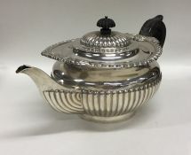 A good silver Georgian style half fluted teapot on