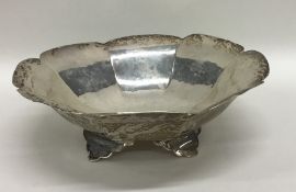 A silver sweet dish with splayed legs. London. App
