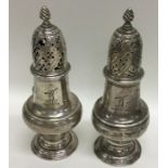 A pair of Georgian silver casters with crested arm