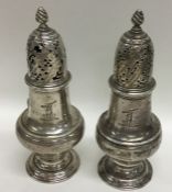A pair of Georgian silver casters with crested arm