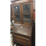 An oak lead glazed bureau bookcase.