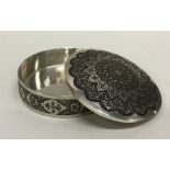 A circular Persian silver box with domed cover dec