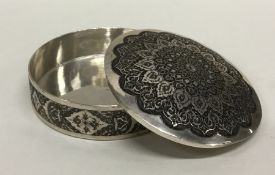 A circular Persian silver box with domed cover dec