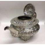 A good Georgian embossed silver teapot with leaf c