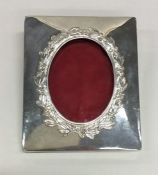 An unusual square silver picture frame decorated w