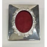 An unusual square silver picture frame decorated w