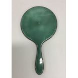 A silver and green enamelled dressing table mirror