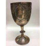 A heavy Victorian silver goblet decorated with flo