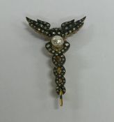A pearl and rose diamond brooch with double wings.