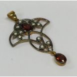 An unusual gold mounted loop pendant inset with ro