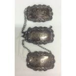 A group of three silver Edwardian wine labels on s