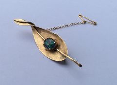 An unusual 14 carat gold opal mounted brooch in th