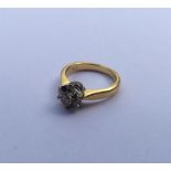 A diamond single stone mounted as a ring in 18 car