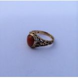 A 9 carat single stone ring inset with coral. Appr