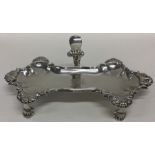 A heavy cast silver snuffer tray with shell border