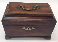 A Georgian mahogany tea caddy with hinged top and