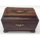 A Georgian mahogany tea caddy with hinged top and