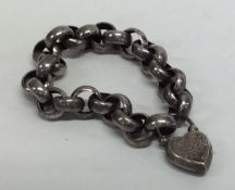 A silver curb link bracelet with engraved padlock