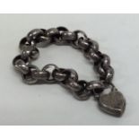 A silver curb link bracelet with engraved padlock