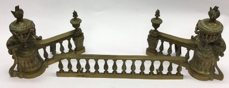 A brass mounted fire curb decorated with swags and