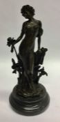 A bronzed figure of a stylish lady on circular ped