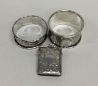 A heavy silver engraved vesta case together with t