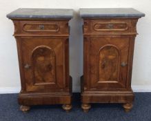 A pair of Continental marble top bedside cabinets