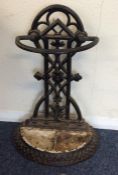 A cast iron stick stand with floral decoration. Es